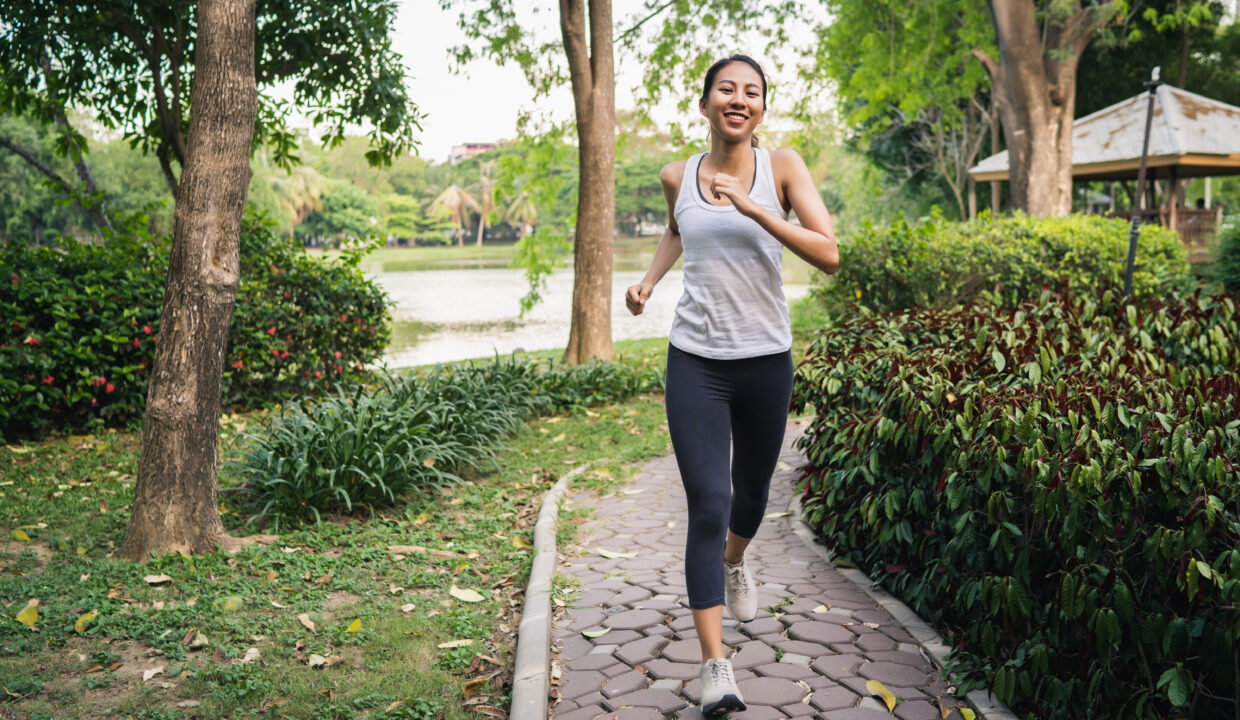 Healthy beautiful young Asian runner woman in sports clothing ru